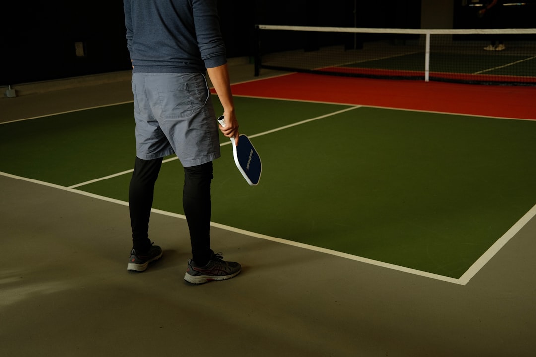 a man standing on a tennis court holding a racquet