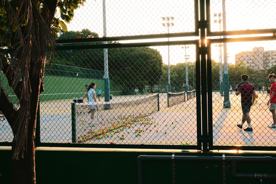 A group of people playing a game of tennis
