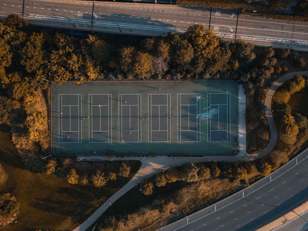 An aerial view of a tennis court on a road