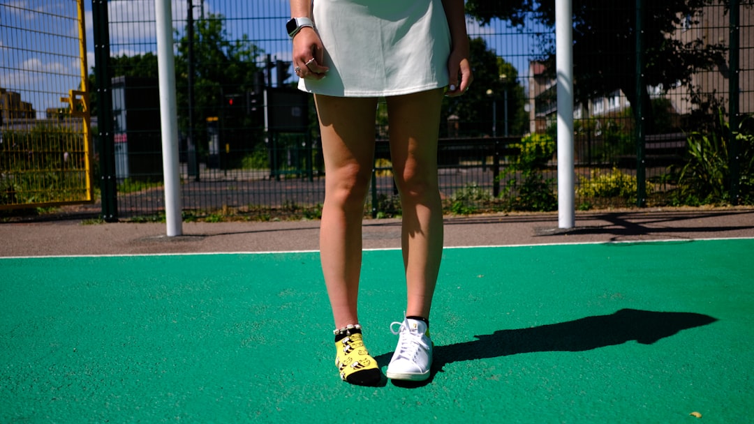 A woman standing on a tennis court holding a racquet