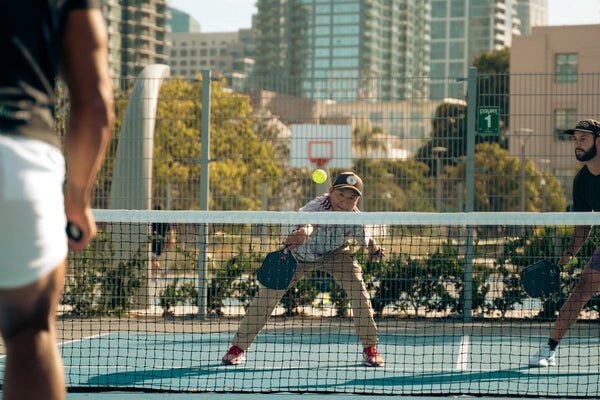A group of men playing a game of tennis