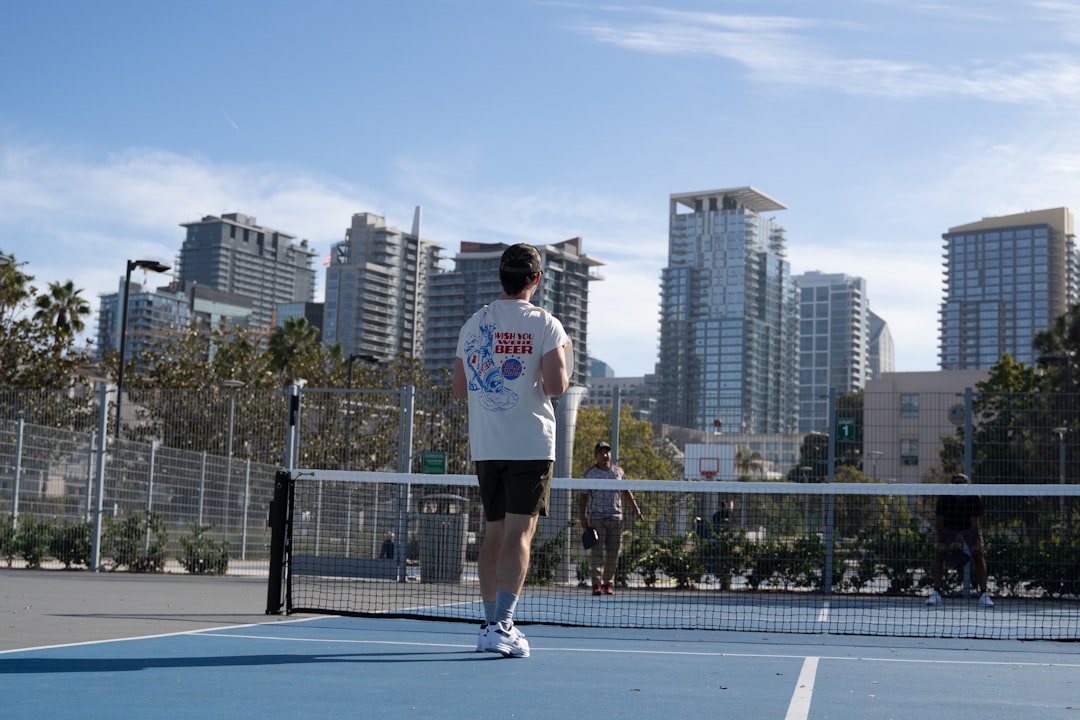 A man standing on a tennis court holding a racquet