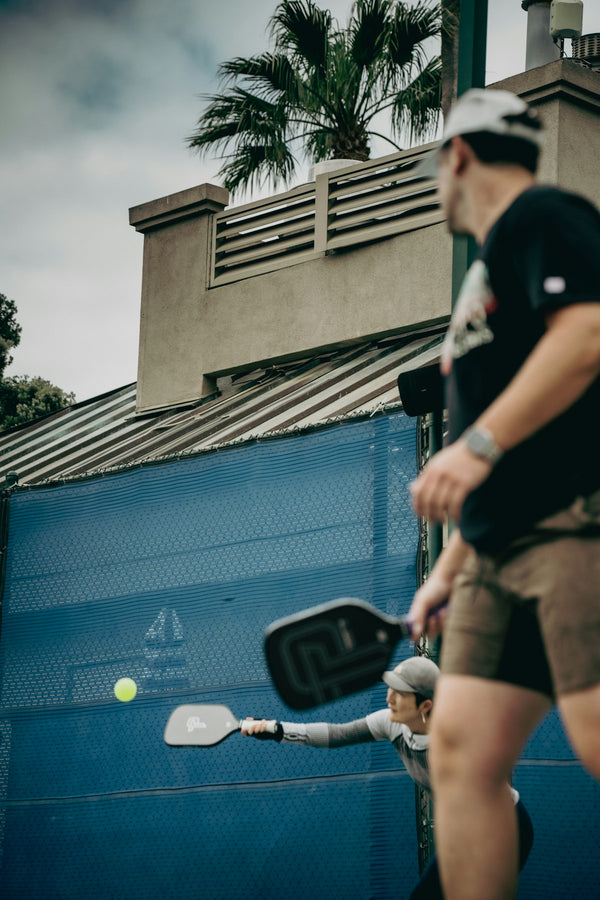 People playing pickleball on an outdoor court