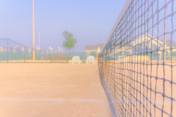 Tennis court net with hazy background