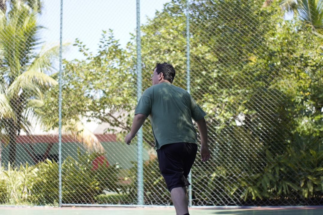 Man playing tennis on a sunny day